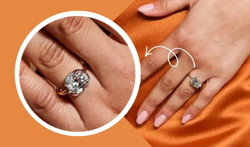 Oval diamond ring highlighted on hand.