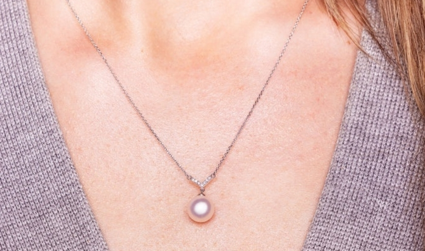 Pearl pendant necklace on neck minimalist jewelry style