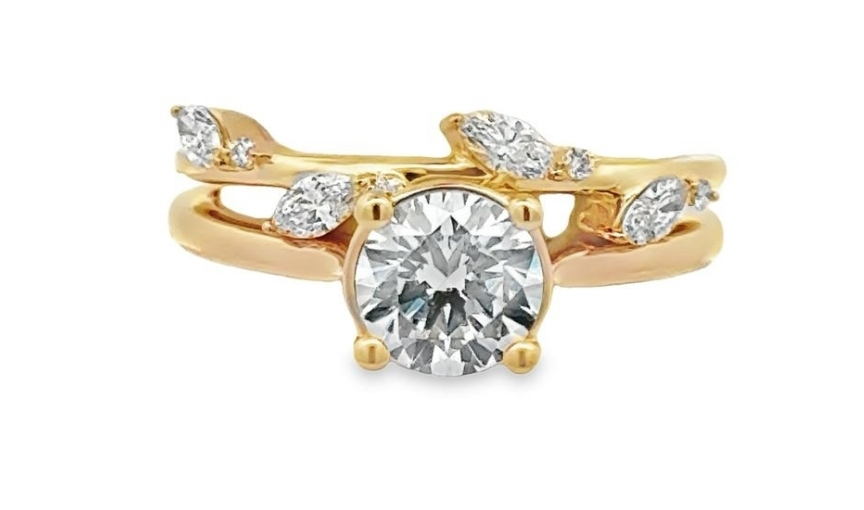 Gold engagement ring with round diamond and side stones