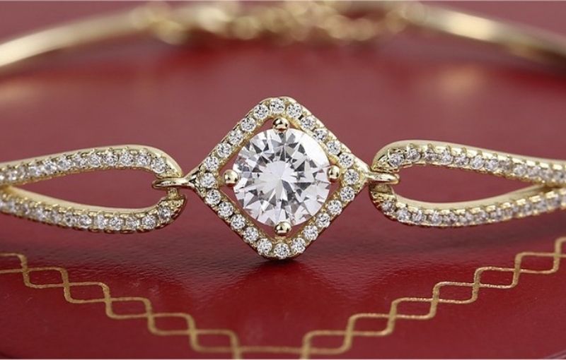 Diamond halo bracelet with gold links close-up