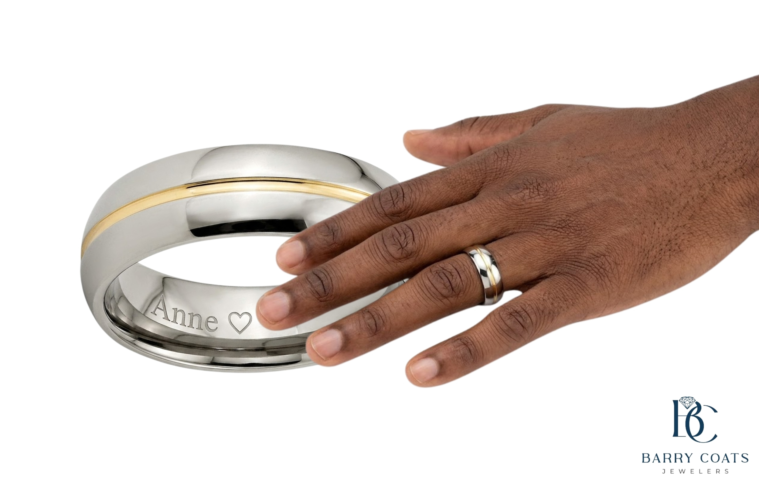 Two-tone engraved men's wedding band on hand White gold diamond pavé eternity ring close-up