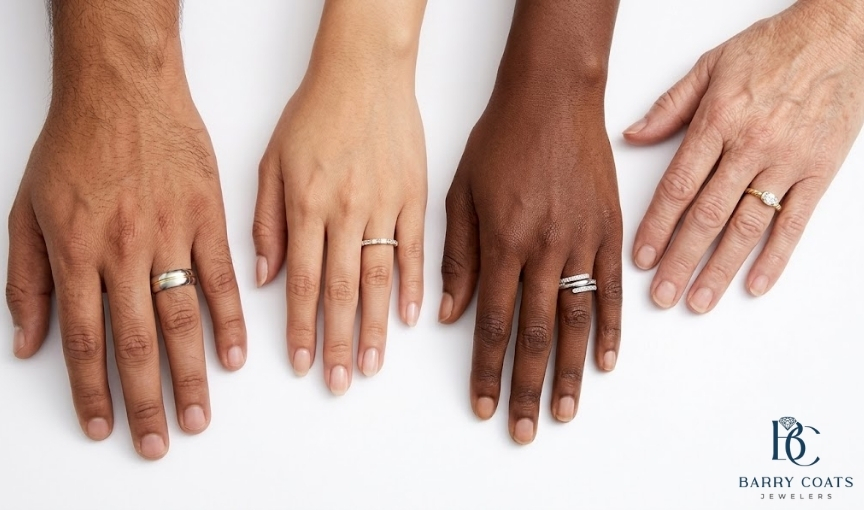Four diverse hands displaying different rings